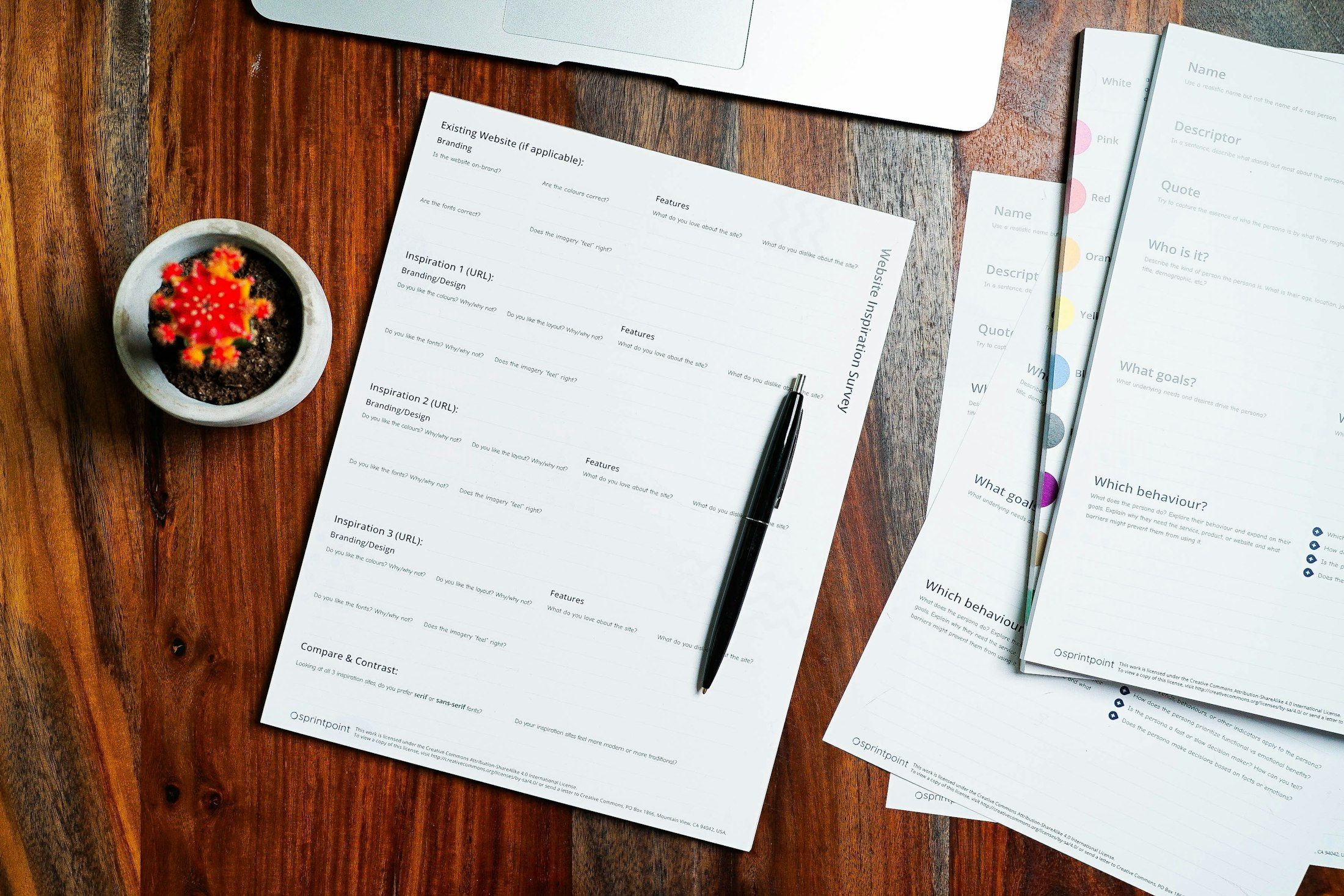 Paperwork and pen on a wooden desk at the Monetaire Accountants office in Worthing